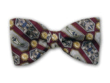 Sun, flowers, paisley, and geometric on burgundy. Silk jacquard bow tie.