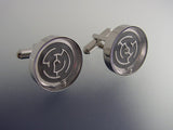 Black maze cufflinks in silver tone casing.