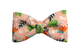 Hawaiian pink bow tie with red Bird of paradise, white Plumeria flowers and tropical green leaves.