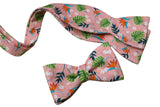 Hawaiian pink bow tie with red Bird of paradise and white Plumeria flower and green leaves.