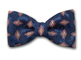 Small red and beige patterns on navy. Silk bow tie for men.