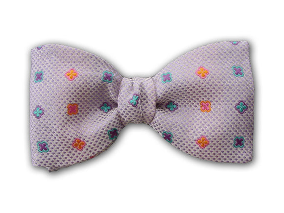 Pink, teal and purple geometric figures on lilac. Woven silk bow tie for men.