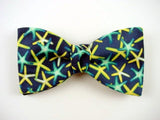 Turquoise and yellow starfish on navy bow tie.